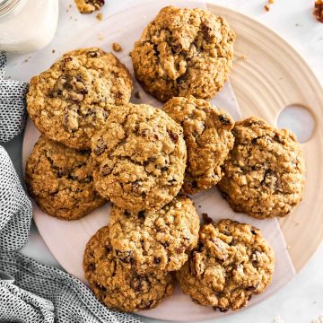 platter with oatmeal raisin cookies next to a bottle of milk