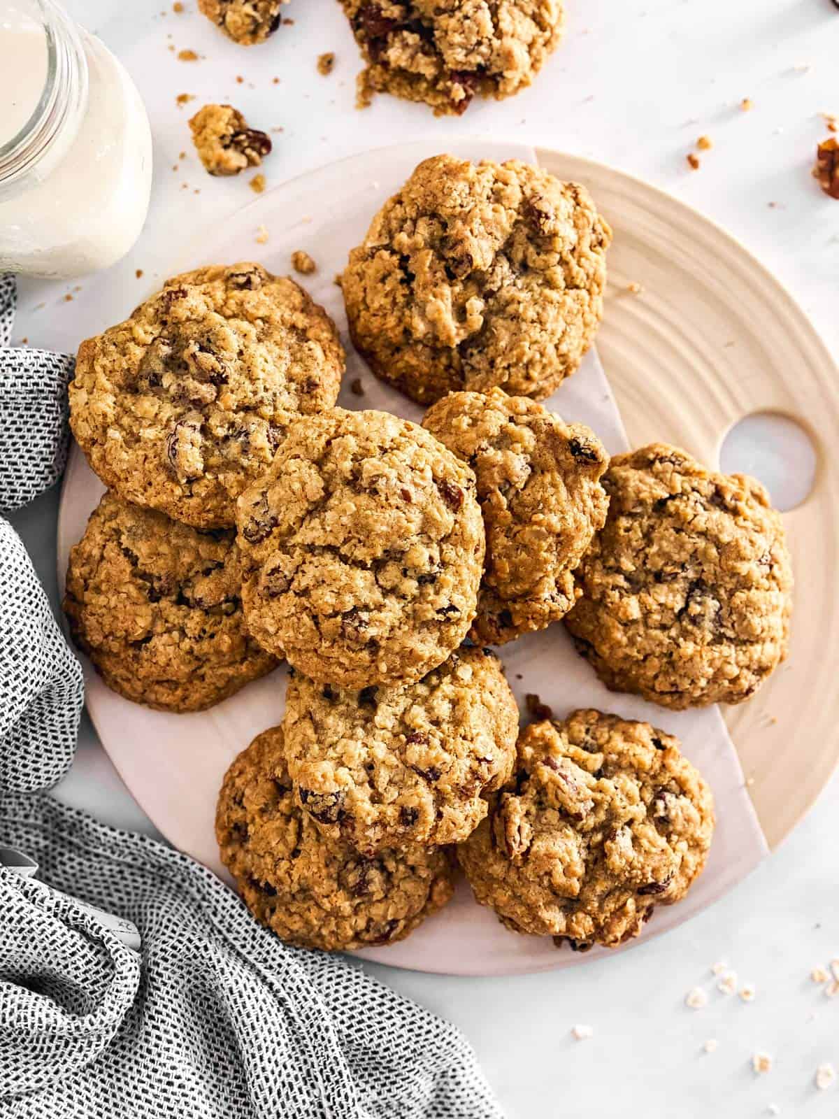 platter with oatmeal raisin cookies next to a bottle of milk