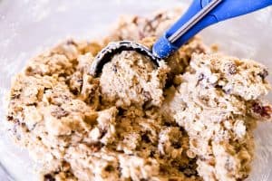 blue cookie scoop scooping oatmeal cookie dough