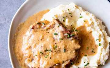 instant pot sour cream pork chops on a plate with mashed potatoes