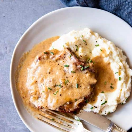 instant pot sour cream pork chops on a plate with mashed potatoes
