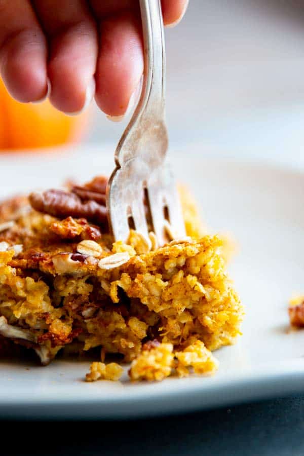 fork sticking in a slice of pumpkin baked oatmeal