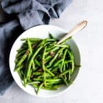 sautéed green beans in a white bowl