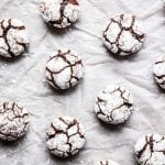 chocolate crinkle cookies on a piece of baking parchment