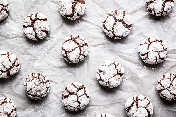 chocolate crinkle cookies on a parchment paper