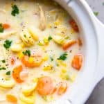 creamy chicken noodle soup in a white crockpot