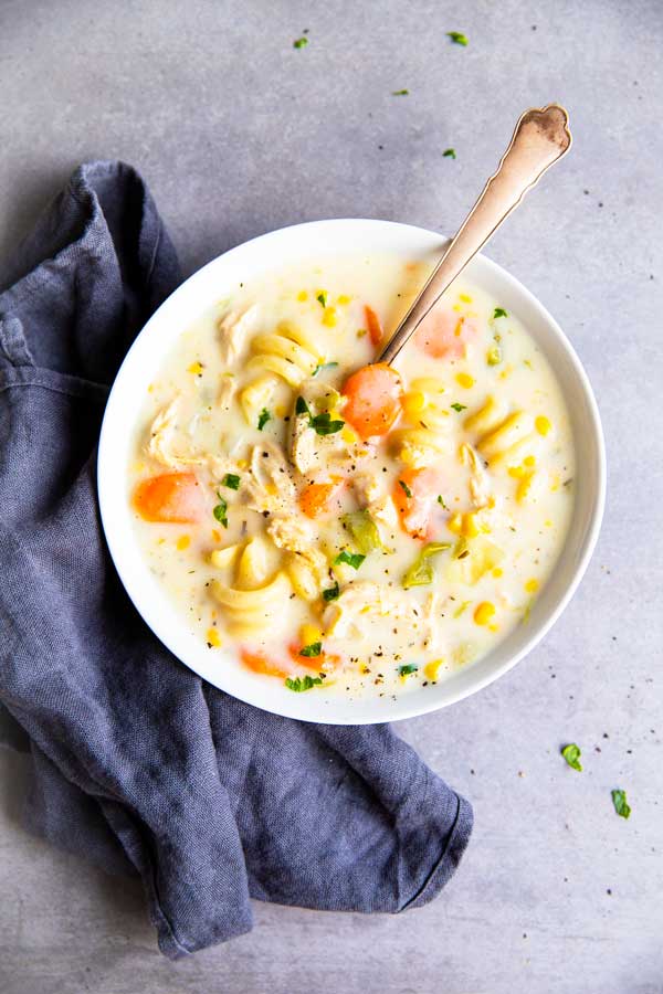 white bowl with chicken noodle soup on the counter