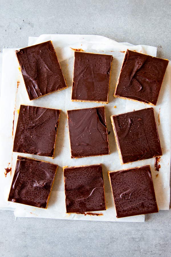 sliced chocolate peanut butter bars on parchment