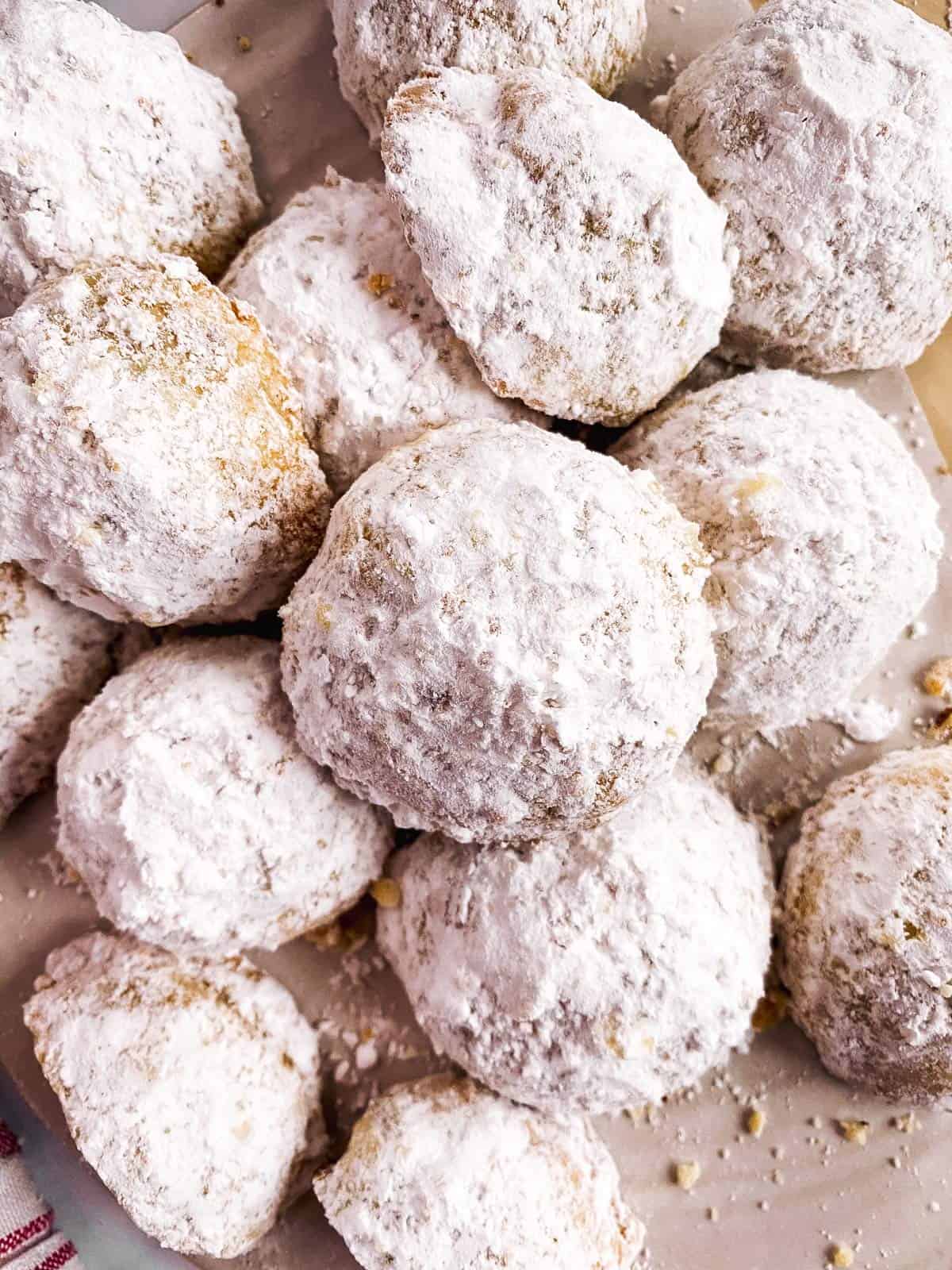 overhead closeup of a pile of pecan snowball cookies