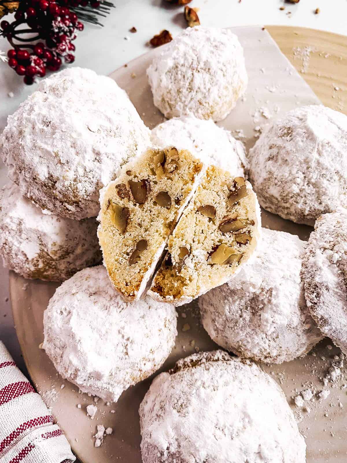 cut open snowball cookie on a cookie platter