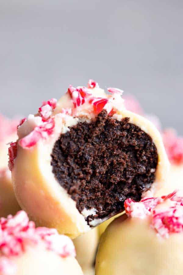 close up photo of a peppermint oreo ball with a bite taken out