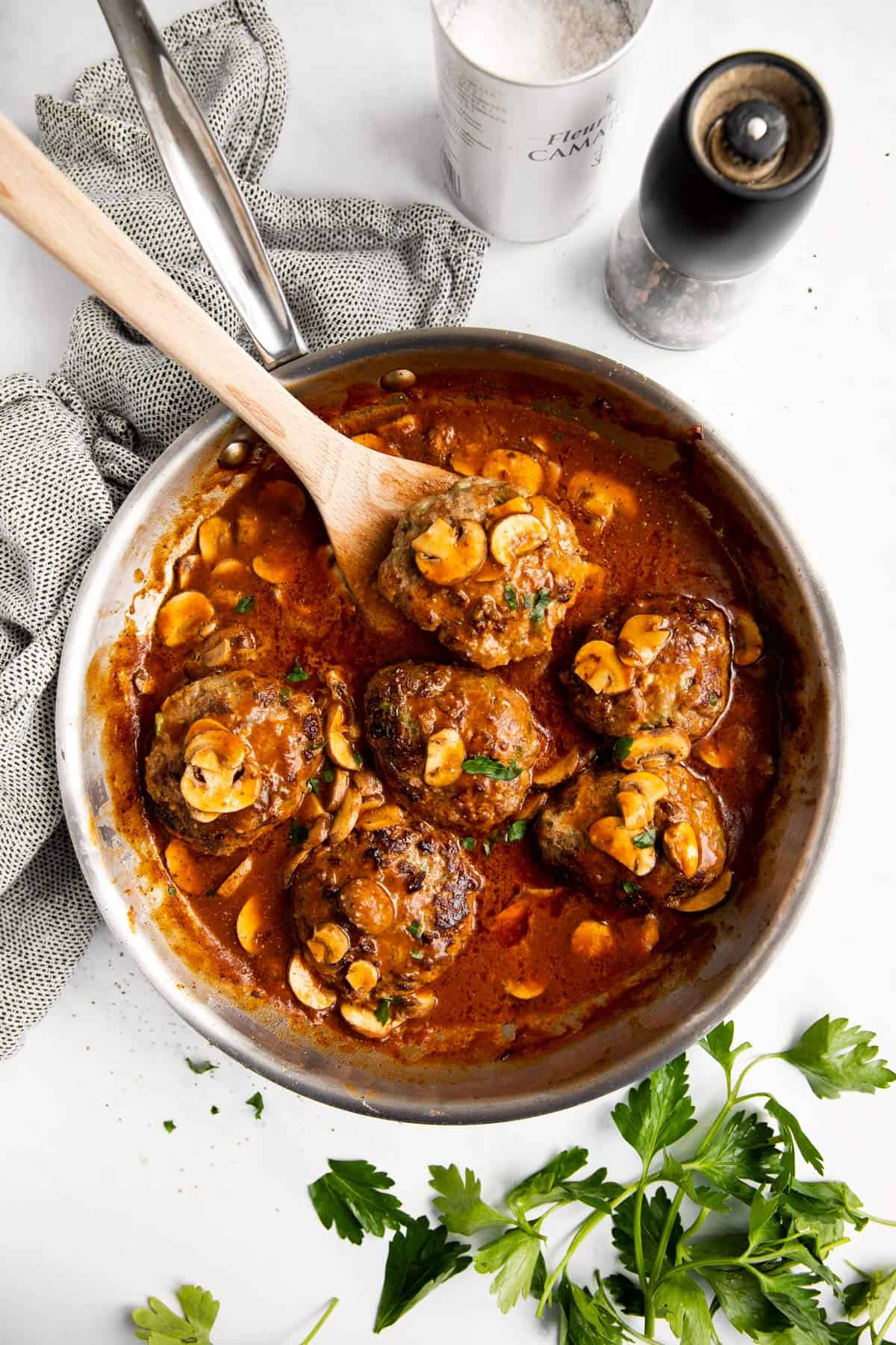 skillet with salisbury steak in mushroom gravy