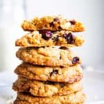 stack of White Chocolate Cranberry Oatmeal Cookies with a halved one on top