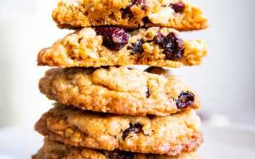 stack of White Chocolate Cranberry Oatmeal Cookies with a halved one on top