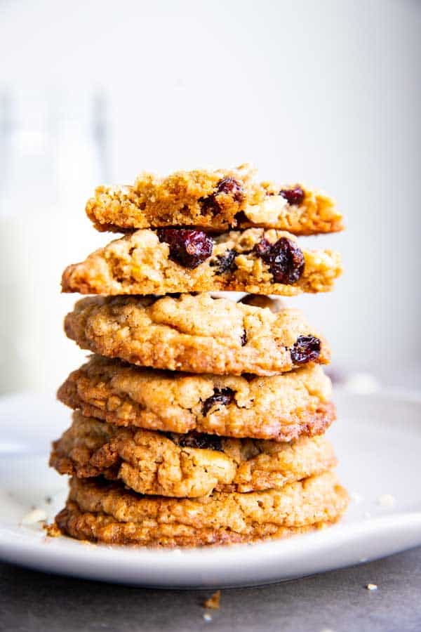 stack of White Chocolate Cranberry Oatmeal Cookies with a halved one on top