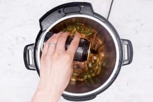 female hand pouring beer into instant pot