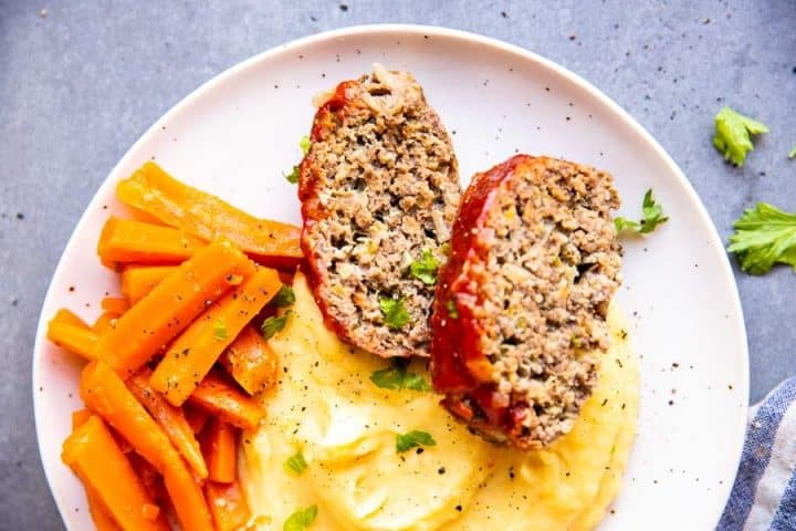 instant pot meatloaf on a plate with mashed potatoes and carrots