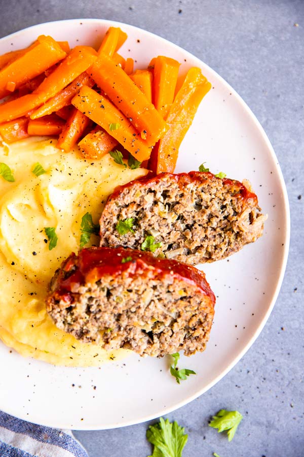 instant pot meatloaf on a plate with mashed potatoes and carrots