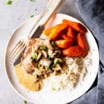 instant pot mushroom pork chops on a plate with rice and carrots