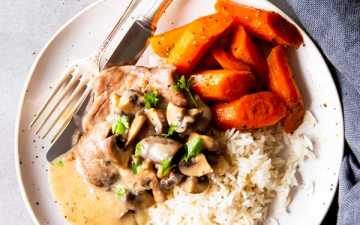 instant pot mushroom pork chops on a plate with rice and carrots