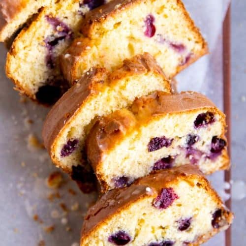 slices of lemon blueberry bread on a wooden board