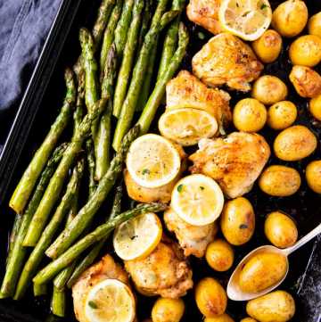 dark sheet pan with chicken, asparagus and potatoes