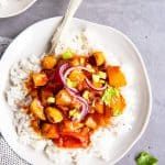 white plate with rice and pineapple chicken