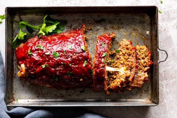 mozzarella stuffed meatloaf on a sheet pan