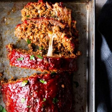 gooey cheese oozing out of a mozzarella stuffed meatloaf