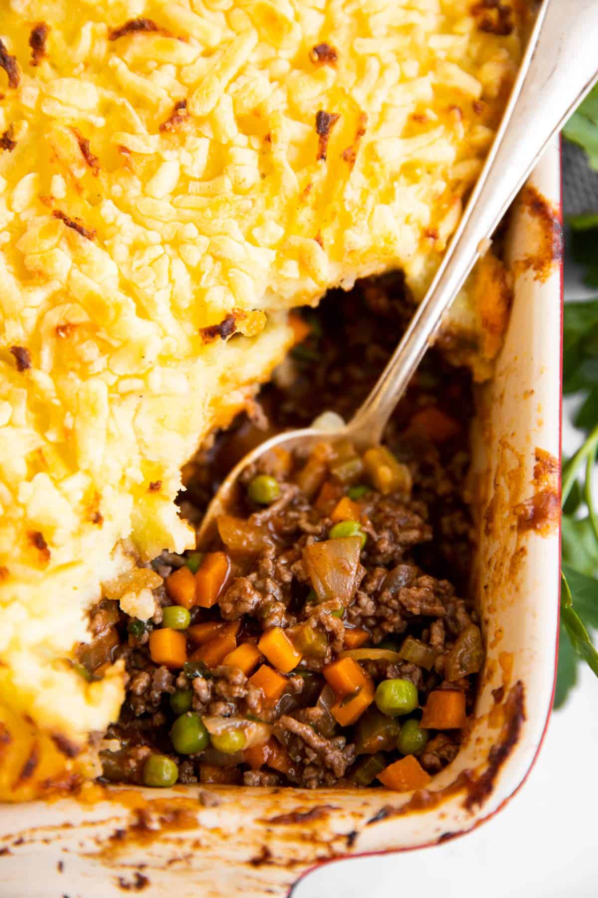 close up of spoon inside shepherd's pie filling