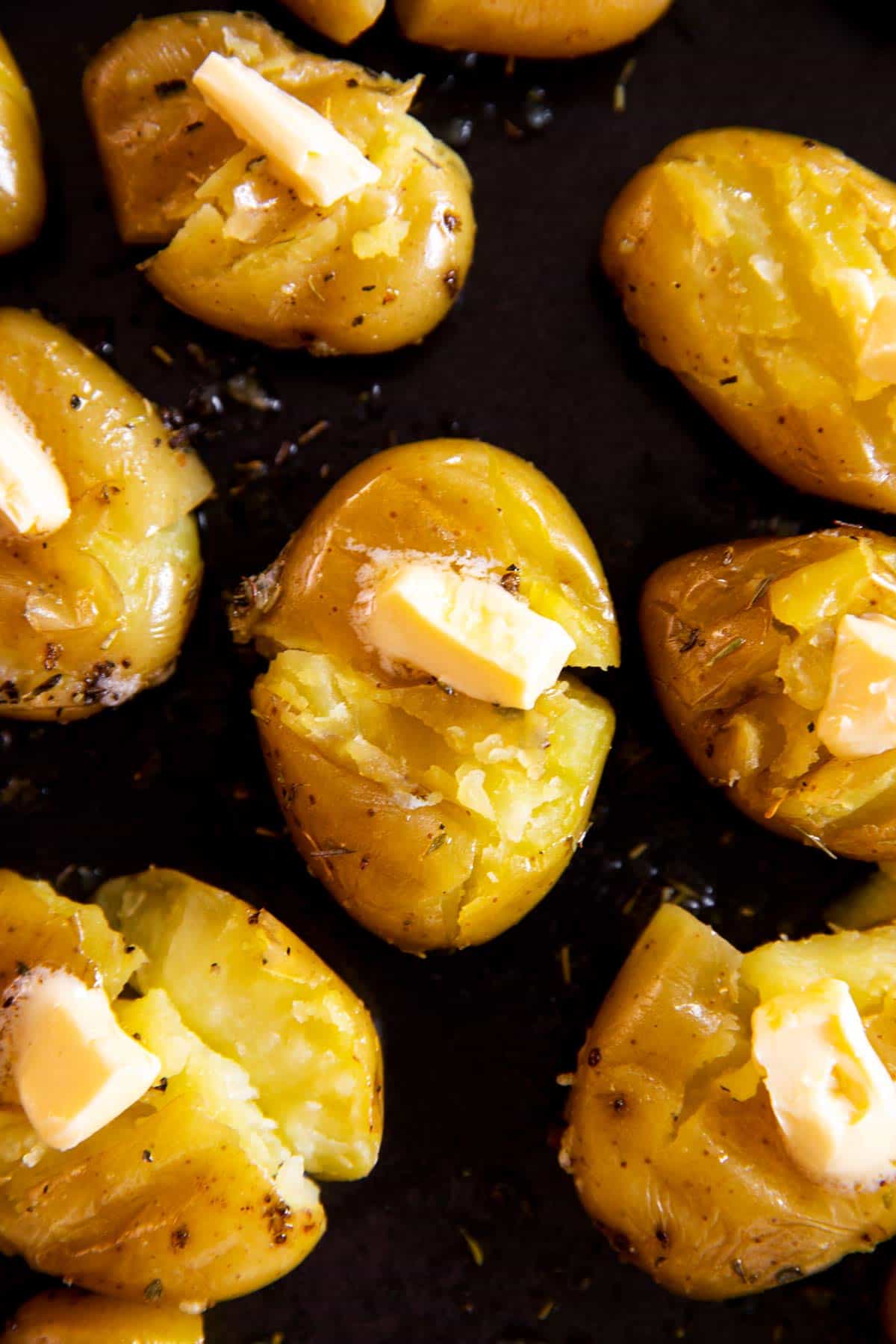 close up photo of smashed potato with piece of butter on top