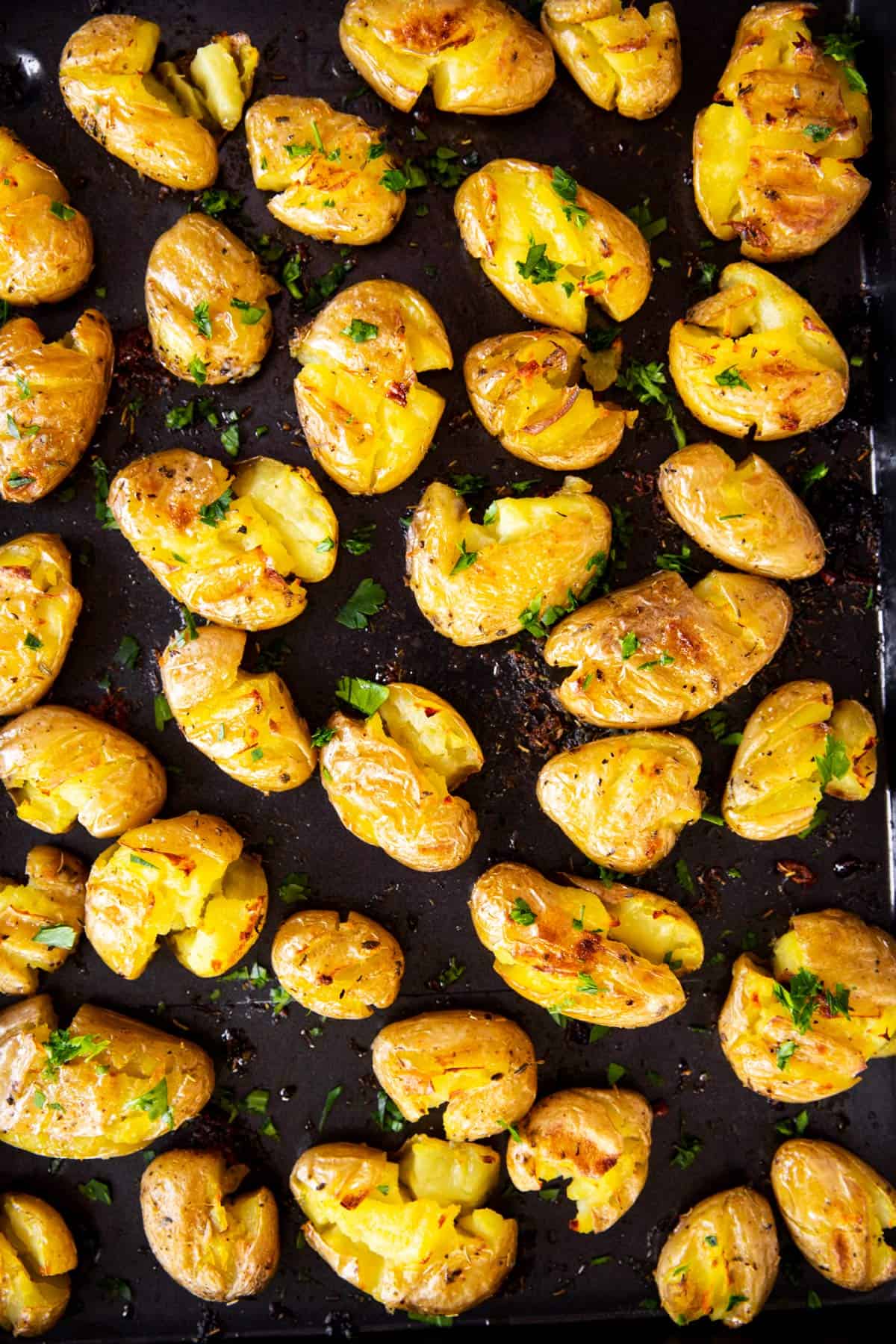 smashed potatoes on black pan