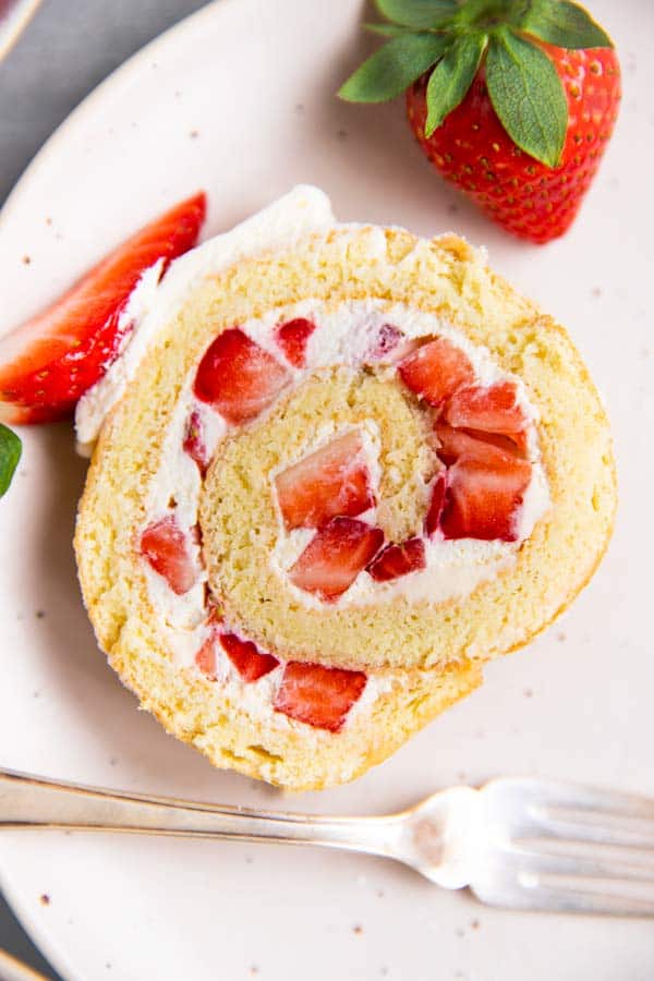strawberry cake roll on a white plate