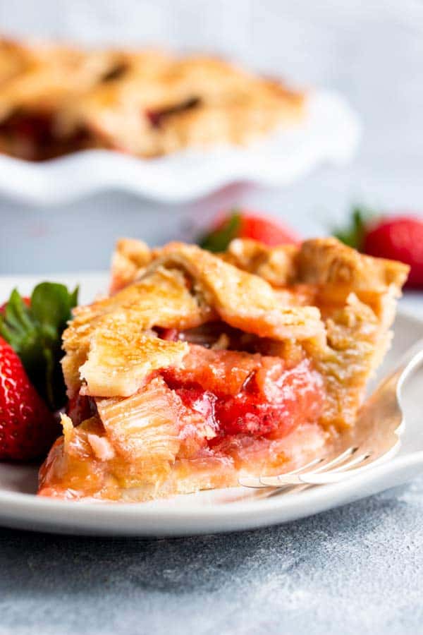 slice of strawberry rhubarb pie on a plate