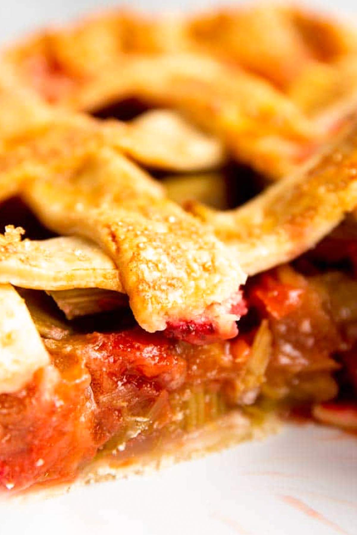 close up photo of strawberry rhubarb pie filling in pie crust