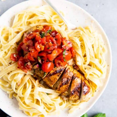 plate with pasta and balsamic bruschetta chicken