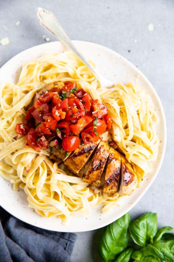 plate with pasta and balsamic bruschetta chicken