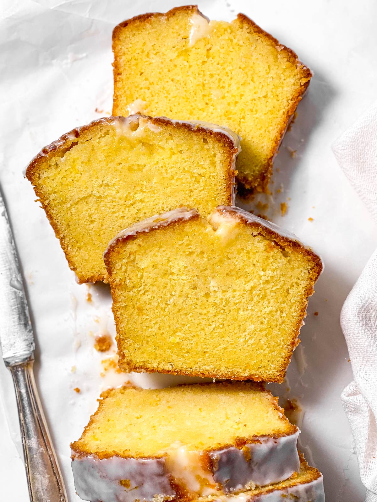 three slices of lemon loaf cake on white surface