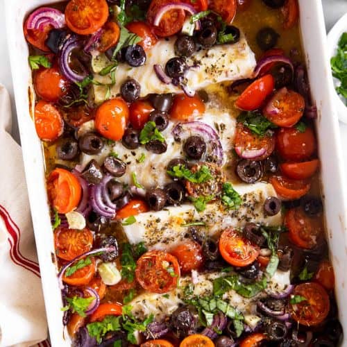 overhead view of white casserole dish filled with mediterranean baked cod