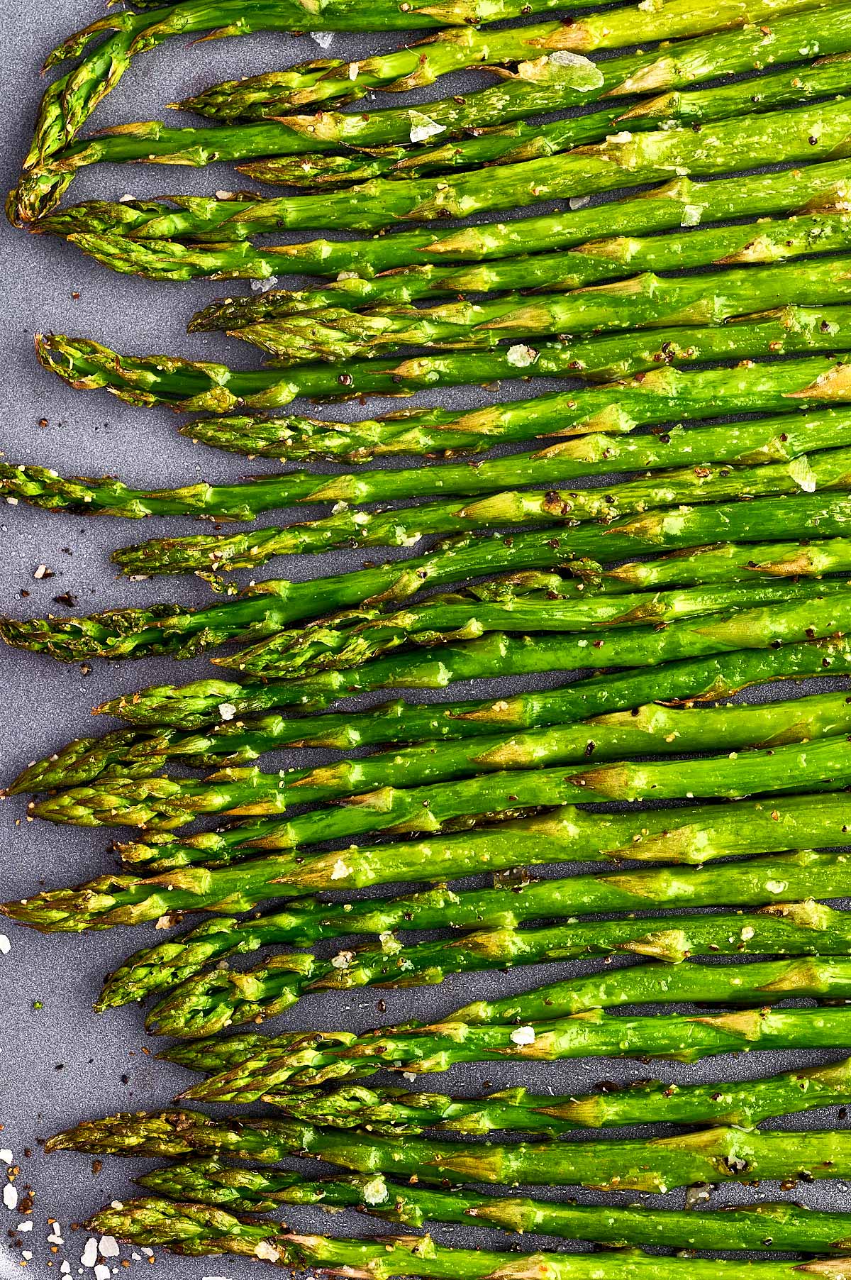 Close up photo of roasted asparagus on a sheet pan.
