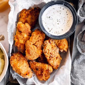 oven fried chicken on dark metal pan