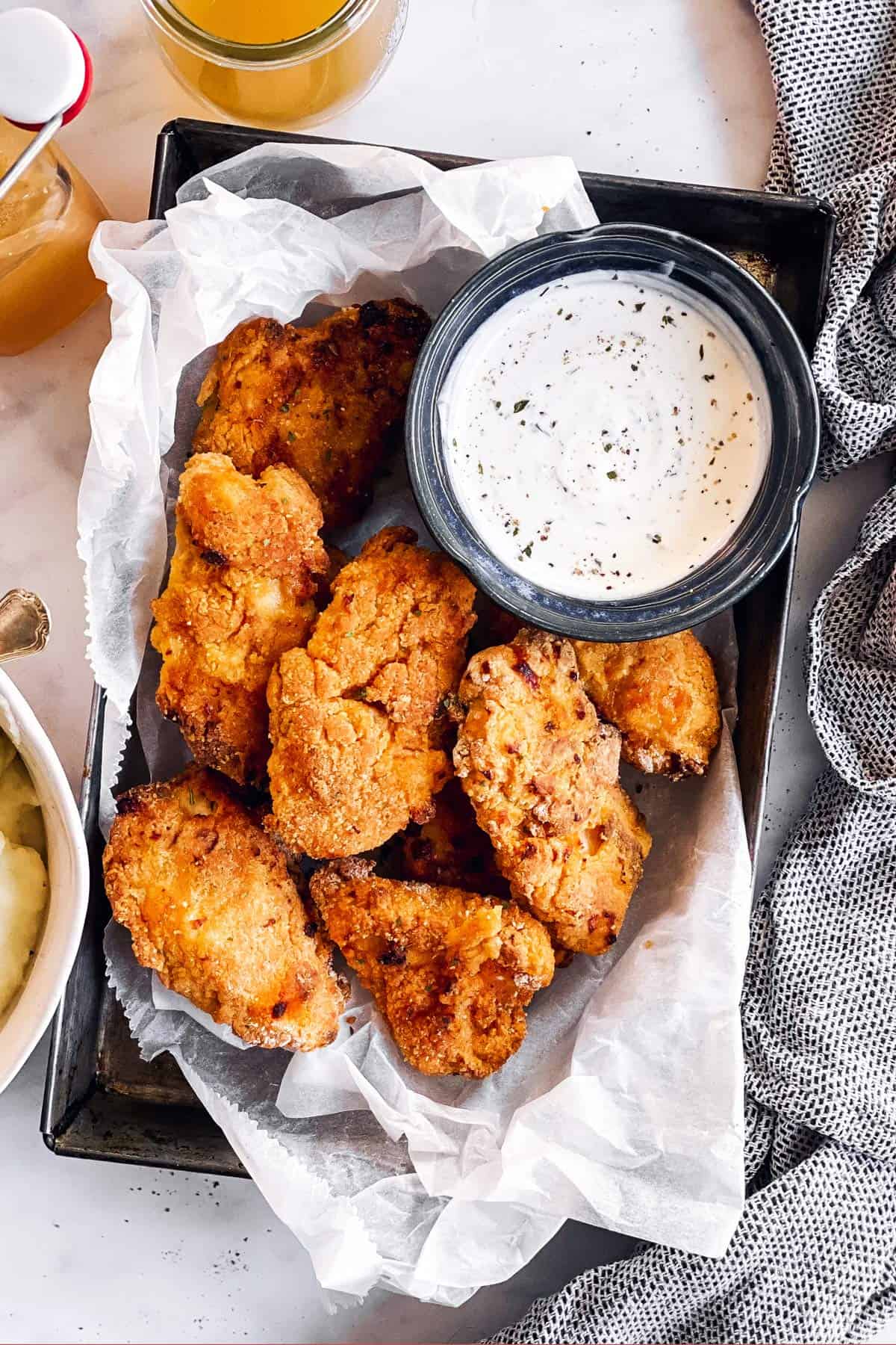 oven fried chicken on dark metal pan