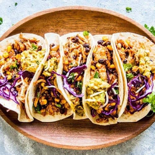 chicken tacos on wooden platter