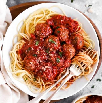 white plate with spaghetti and meatballs
