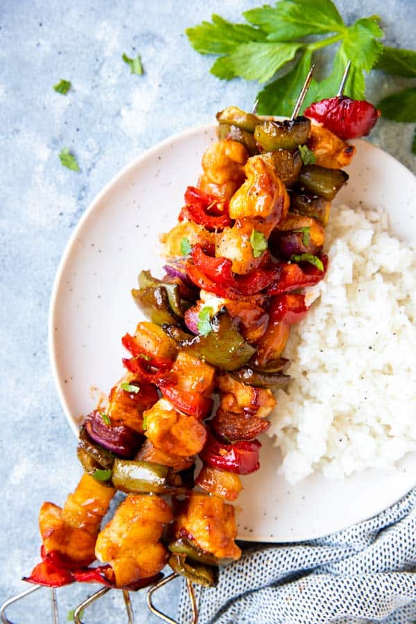 pineapple bbq chicken kabobs on a plate with rice
