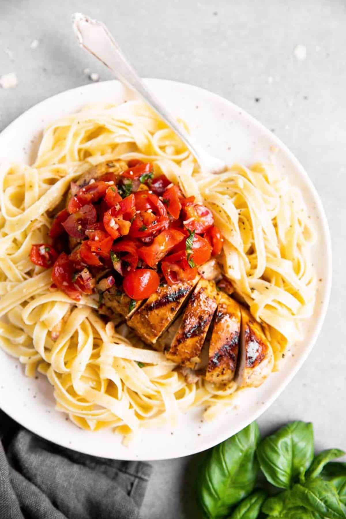 plate with pasta and balsamic bruschetta chicken