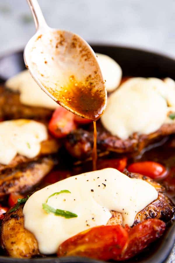 drizzling balsamic glaze over caprese chicken