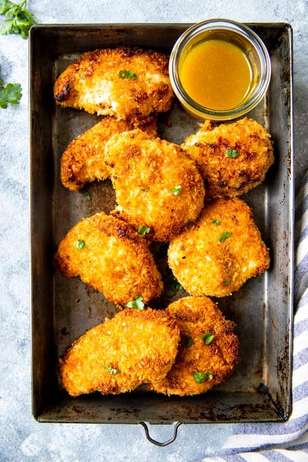 dark baking pan with coconut chicken