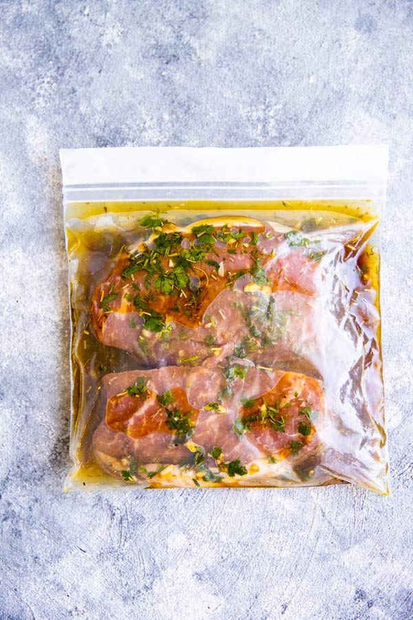 ziploc bag with steaks in marinade