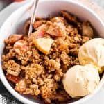 white bowl filled with apple crisp and ice cream